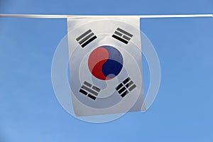 Mini fabric rail flag of South Korea, a white rectangular background, a red and blue Taeguk, symbolizing balance.