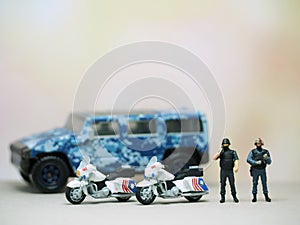 Mini figure of police character at outdoor with blurred background. Military concept design.