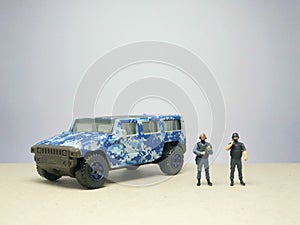 Mini figure of police character at outdoor with blurred background. Military concept design.