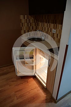 Mini fridge with open door in the kitchen