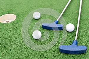 Mini Golf club and ball on the artificial grass