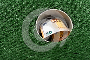 Mini Golf club, money on the artificial grass