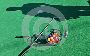 Mini golf putt putt clubs colorful balls shadow