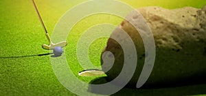 mini golf - putter hit the ball on green artificial grass. banner