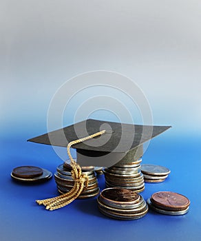Grad cap and coins on blue