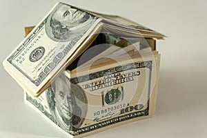 Mini house of dollars banknote. Concept of Investment property, Mortgage concept. Investment risk and uncertainty