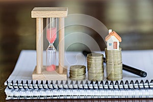 Mini house on stack of coins,Money and house, Mortgage, Savings money for buy house and loan to business investment for real