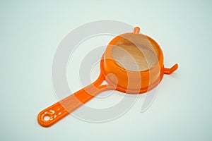 Mini kitchen sieve with orange plastic handle