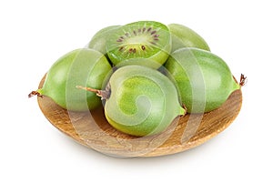 mini kiwi baby fruit or actinidia arguta in wooden bowl isolated on white background with full depth of field.