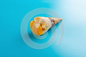 Mini mango or orange flavor ice cream cone on blue