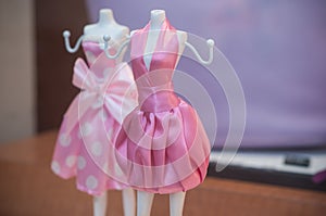 Mini mannequin with pink dress in fashion store for w