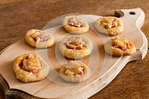 Mini pizzas on cutting board