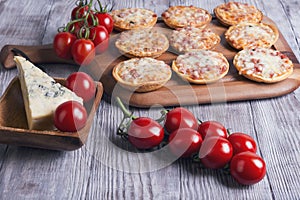 Mini pizzas on a wooden table