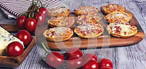 Mini pizzas on a wooden table