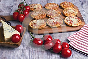 Mini pizzas on a wooden table