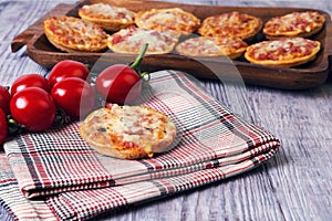 Mini pizzas on a wooden table