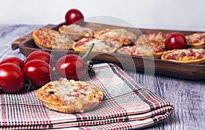 Mini pizzas on a wooden table