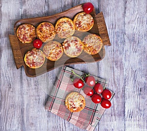 Mini pizzas on a wooden table