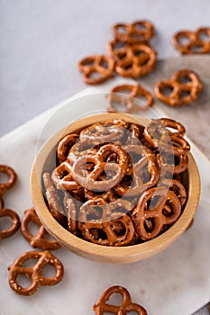 Mini pretzels in a wooden bowl, salty snack