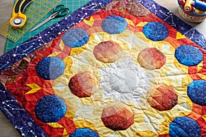 Mini quilt with the image of volumetric spheres, sewing and quilting accessories