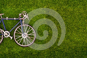 Mini retro toy bike on the grass meadow