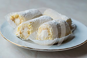 Mini Roll Cake with Vanilla Cream, Coconut and Powdered Sugar.