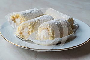 Mini Roll Cake with Vanilla Cream, Coconut and Powdered Sugar.