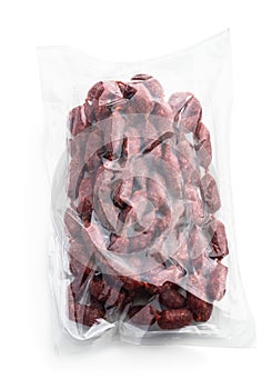 Mini salami sausagesin plastic pack isolated on white