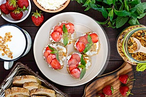 Mini sandwiches with cottage cheese, fresh strawberries, decorated with mint leaves