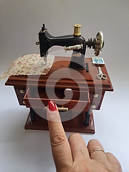 Mini sewing machine isolated on white background.