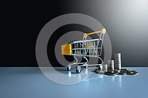 Mini shopping cart with coins stacks,Finance and money shopping concept