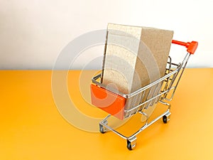 Mini shopping cart with crate in the shopping making payment on isolated backgrounds