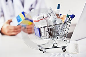 Mini shopping cart full of medicines in pharmacy