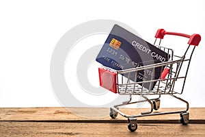 Mini shopping cart on table for work and credit card for work to