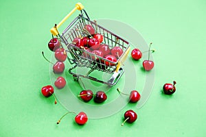 Mini shoppingcart with red ripe cherries photo