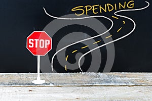 Mini STOP sign on the road to SPENDING