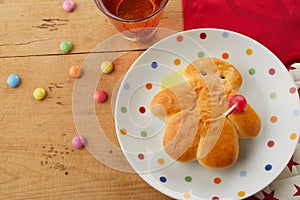 Mini Stuten bread man on a polka dot plate photo