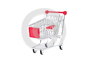 Mini toy metal shopping trolley cart with red handle and four black wheels isolated on white background. Supermarket shopping,