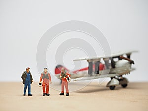 Mini toy at table with blurred background. Aircraft crew concept design.