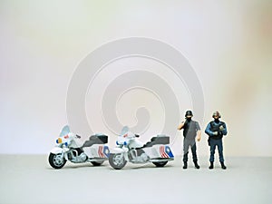 Mini toy at table with blurred background. Policeman concept design.