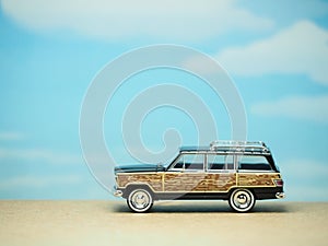 Mini toy at table with blurred background. Traveling car concept design.