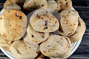 Mini traditional Egyptian flat bread with wheat bran and flour, small Aish Baladi or small bread baked in extremely hot ovens, it