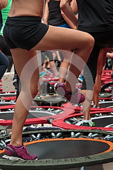 Mini Trampoline Workout: Girl doing Fitness Exercise in Class at