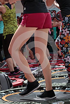 Mini Trampoline Workout: Girl doing Fitness Exercise in Class at Gym