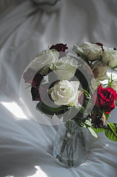 Mini vase with red, white, and purple roses