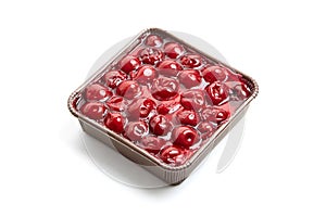 Mini viennese cherry pie in tray isolated on white. Biscuit cake with cherries under jelly. Mini pie with a vibrant burst of