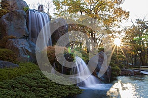 Mini water fall in autumn at japan.