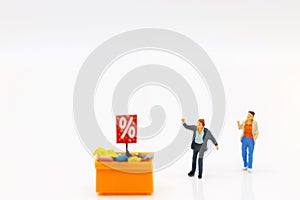 Miniatrue people: Shoppers buy goods on sale with discount tray. Tourism, shopping or business concept