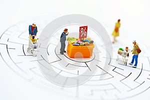 Miniatrue people: Shoppers buy goods on sale with discount tray. Tourism, shopping or business concept