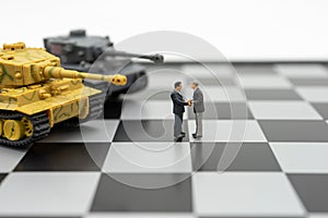 Miniature 2 people businessmen Shake hands standing on a chessboard with a chess piece on the back Negotiating in business. as